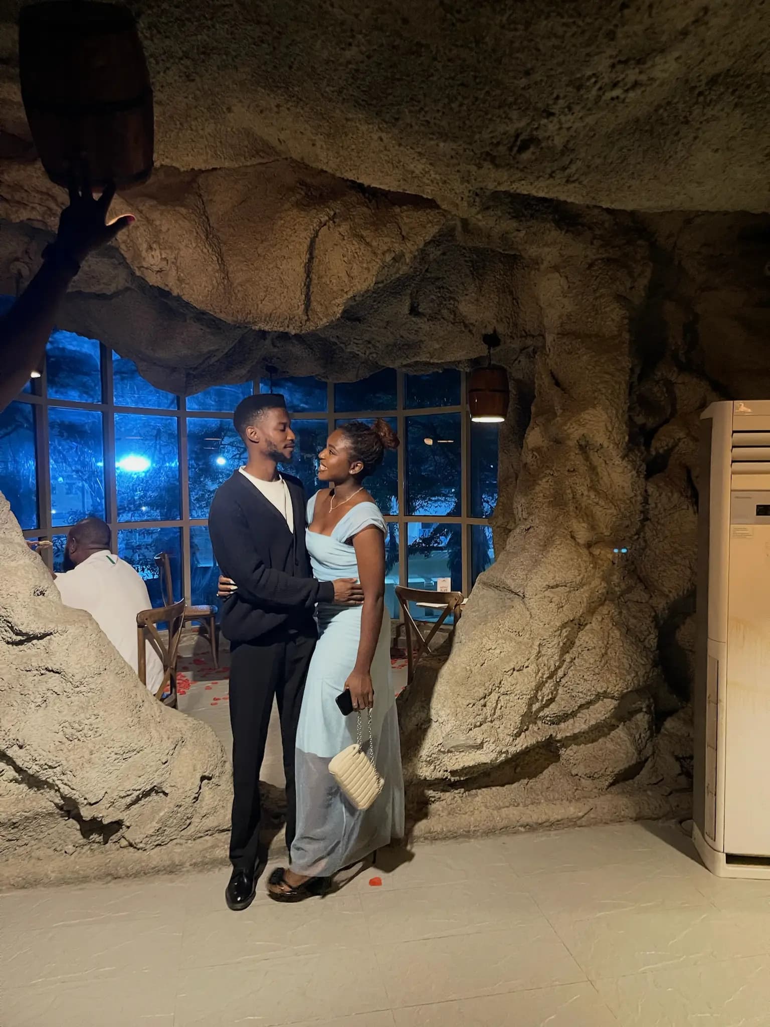 Bride and groom walking together at night